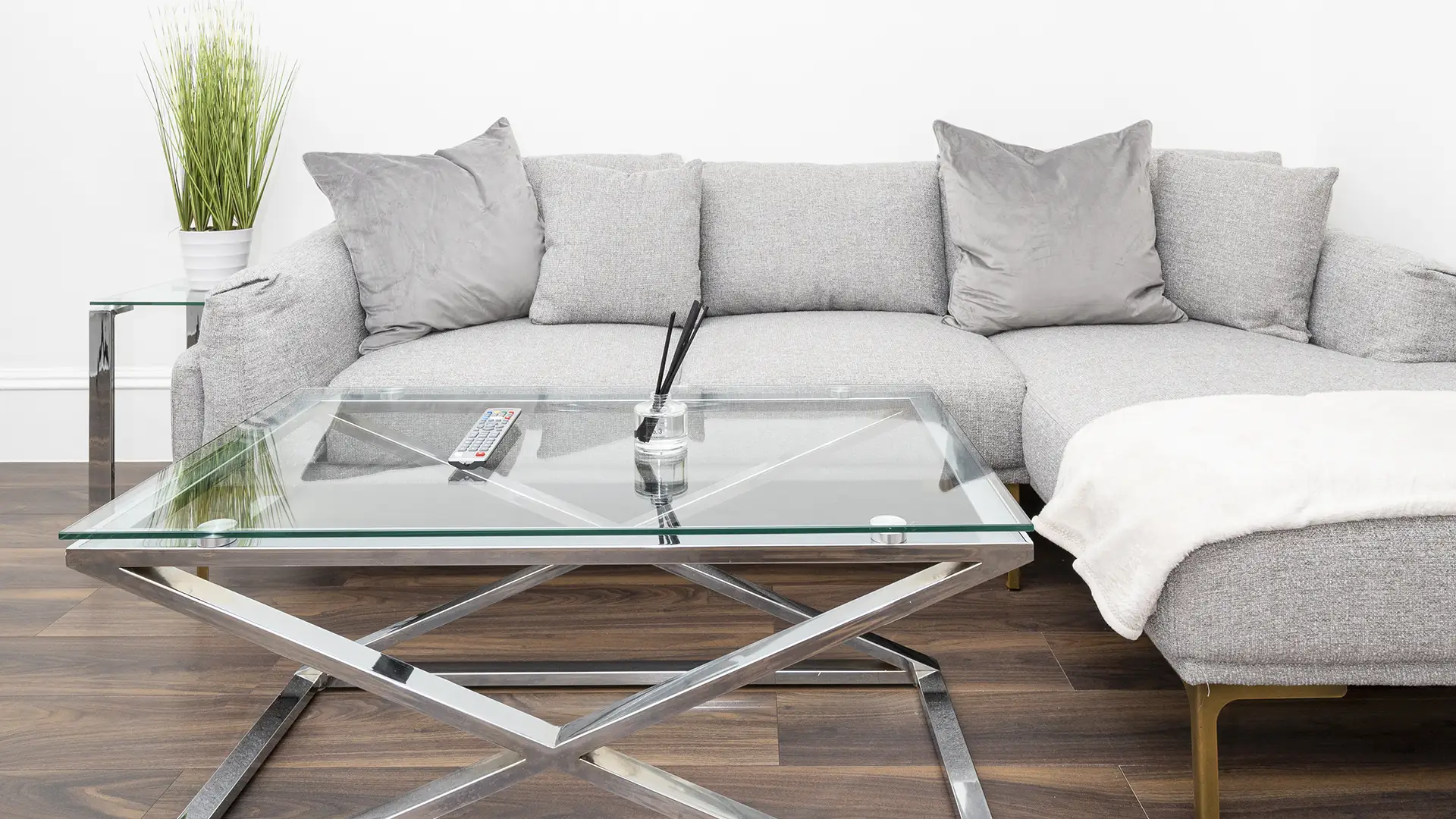 spacious and comfortable couch with a sturdy glass table