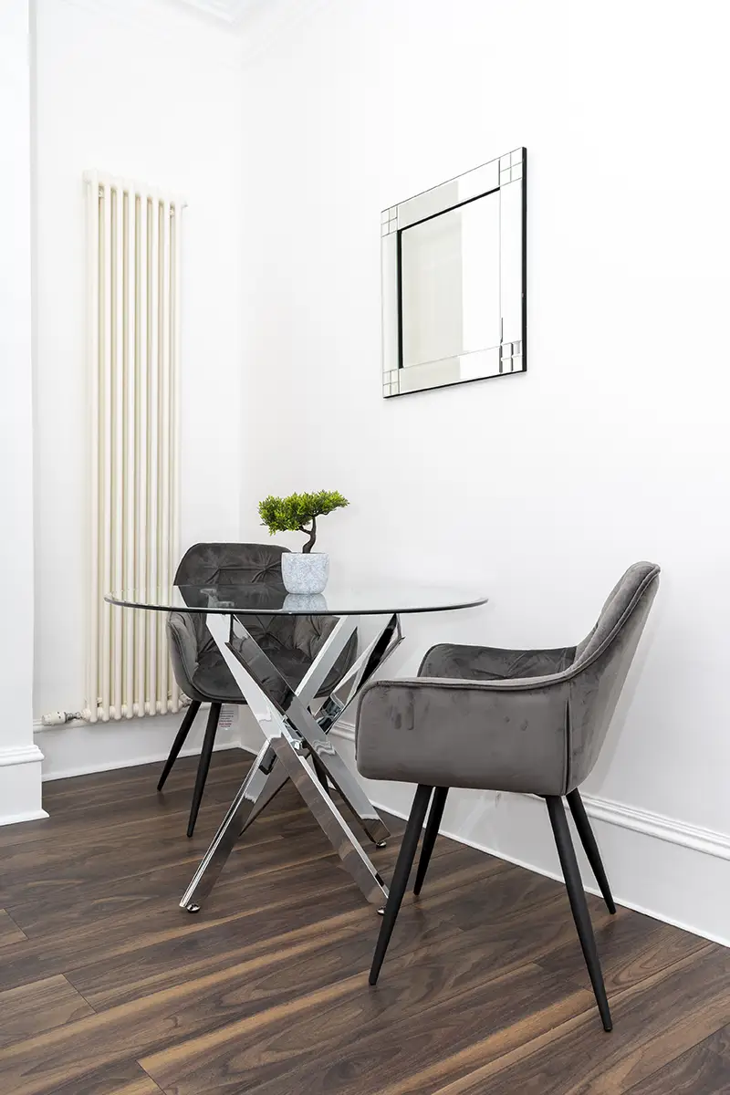 2 elegant chairs along with a glass and metallic table