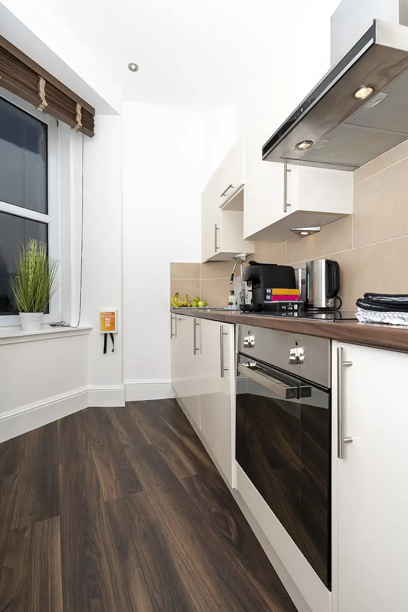 Aberdeen apartment kitchen with coffee maker, toaster, oven and fruits